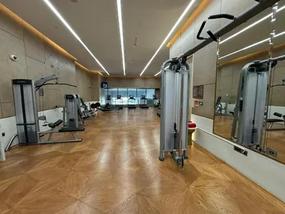 a large room with a gym with tread machines at Sea View Apartment by St Regis 5 stars Infinity Pool in Dubai