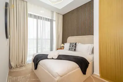 a bedroom with a bed and a large window at Magnificent Canal View 2 Bhk 6 pax in Dubai