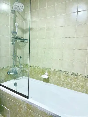 a bathroom with a bath tub with a shower at Stunning 2BR Marina View Apt Close to JBR in Dubai