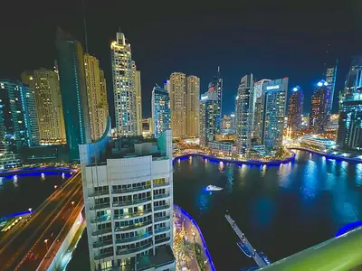 a view of a city at night with at Stunning 2BR Marina View Apt Close to JBR in Dubai