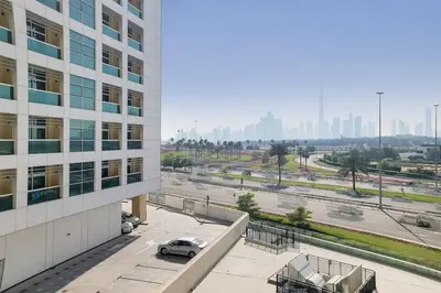 a car parked outside of a building next to a street at O Ten Al Jaddaf - Stylish Studio in Dubai
