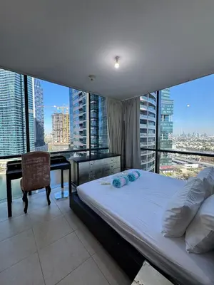 a bedroom with a bed and a desk with a view at Click Stay - JLT - 2 Bedroom & Balcony Lakes View Entire Apartment -SS in Dubai