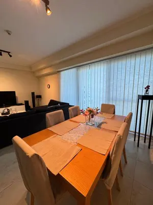 a dining room table with chairs and a couch at Click Stay - JLT - 2 Bedroom & Balcony Lakes View Entire Apartment -SS in Dubai