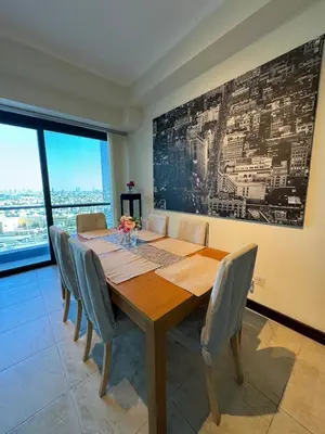 a dining room with a wooden table and chairs at Click Stay - JLT - 2 Bedroom & Balcony Lakes View Entire Apartment -SS in Dubai