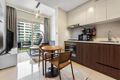 a kitchen with a table and chairs in a kitchen at Apartment in Downtown Dubai in Dubai
