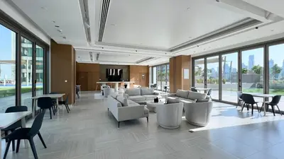 a large lobby with couches and tables and windows at Luxury Stay Burj Views and Direct Dubai Mall Access in Dubai