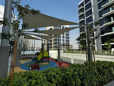 a playground with a slide in a building at Sunlit serenity Studio Azizi Riviera in Dubai
