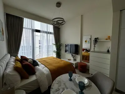 a bedroom with a bed and a large window at Sunlit serenity Studio Azizi Riviera in Dubai