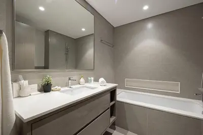 a bathroom with a tub and a sink and a bath tub at Gogoto1 Ultra LUX Burj View Spacious High Floor PS5 NYE Fireworks View in Dubai