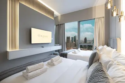 a hotel room with two beds and a flat screen tv at Gogoto1 Ultra LUX Burj View Spacious High Floor PS5 NYE Fireworks View in Dubai
