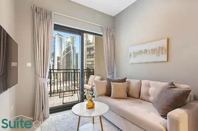 a living room with a couch and a large window at Modern and Relaxing 1 Bedroom in Zada Tower in Dubai