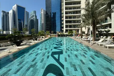 a large swimming pool in a city with buildings at Modern and Relaxing 1 Bedroom in Zada Tower in Dubai