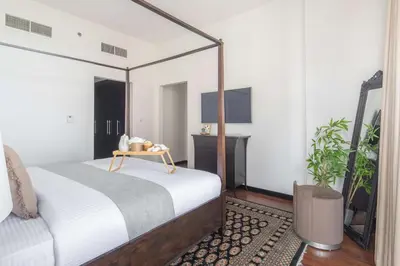 a bedroom with a bed and a mirror at Frank Porter - Green Lakes in Dubai