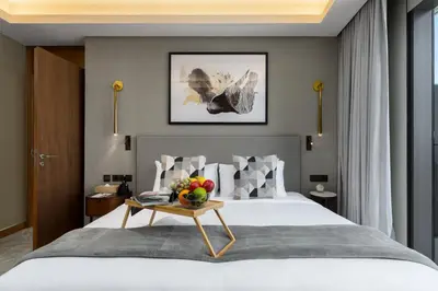 a bedroom with a bed with a table with fruit on it at Maison Privee - Exclusive Apt with Unmatched Burj Khalifa Views in Dubai