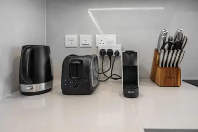 a group of appliances sitting on top of a counter at Brand new 1BD apartment in Canal Front Residence in Dubai