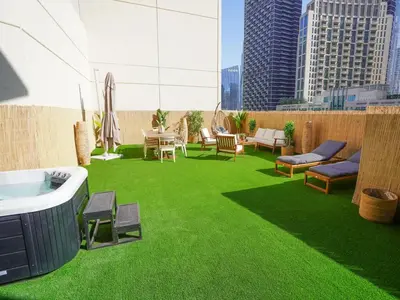 a rooftop patio with green grass on a building at 3BR Loft I Burj Khalifa & Mall in Dubai