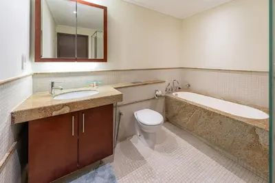a bathroom with a tub and a toilet and a sink at Downtown Retreat 1BR with Skyline Views & WiFi in Dubai