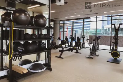 a gym with lots of equipment in a building at Mira Holiday Homes - Bright studio with Burj Khalifa view in Business Bay in Dubai
