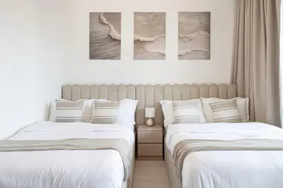 two beds sitting next to each other in a bedroom at Glorious Burj Khalifa and Fountain views in Dubai
