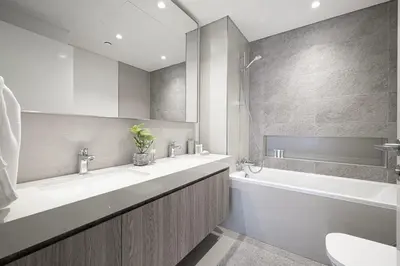 a bathroom with two sinks and a tub and a toilet at Glorious Burj Khalifa and Fountain views in Dubai