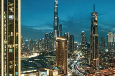 a view of a city skyline at night at Glorious Burj Khalifa and Fountain views in Dubai