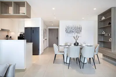 a kitchen and dining room with a table and chairs at Glorious Burj Khalifa and Fountain views in Dubai