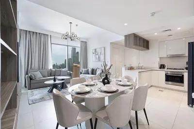a kitchen and living room with a table and chairs at Glorious Burj Khalifa and Fountain views in Dubai