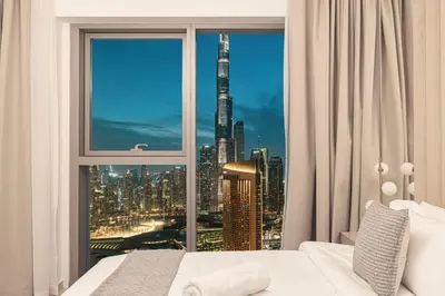 a bedroom with a large window with a view of a city at Glorious Burj Khalifa and Fountain views in Dubai