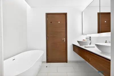a white bathroom with a tub and two sinks at Lush 2BR & Maids City Walk with Burj Khalifa View in Dubai