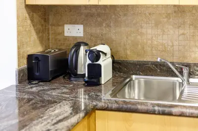 a kitchen counter with a sink and a toaster at Full Lake View - 1BR Apartment in Goldcrest Views,Cluster V,JLT - Allsopp & Allsopp in Dubai