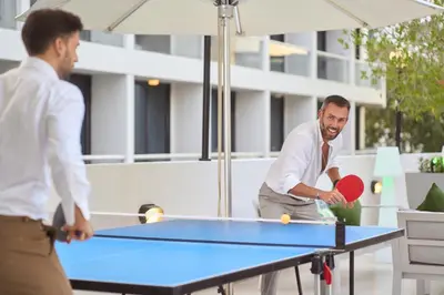 two men playing a game of ping pong at Golden Sands Bur Dubai in Dubai