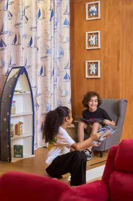 a boy and a girl sitting in a chair at Golden Sands Bur Dubai in Dubai