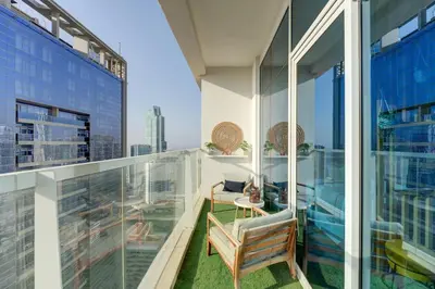an apartment balcony with a view of a city at HiGuest - New! Stunning sea view studio, Balcony, Pool in Dubai