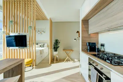 a kitchen with a sink and a stove top oven at HiGuest - New! Stunning sea view studio, Balcony, Pool in Dubai