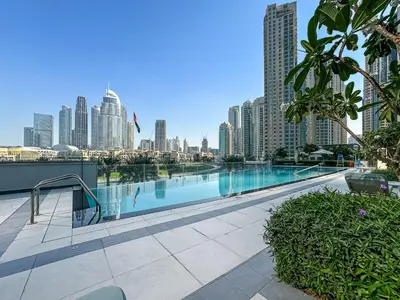 a swimming pool with a city skyline in the background at Luxury 3BR Apartment with Burj Khalifa Views in Dubai