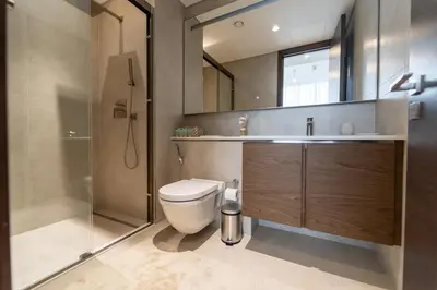 a bathroom with a toilet and a sink and a shower at Modern 1BR in Creek Vistas Grande, Burj Khalifa View in Dubai