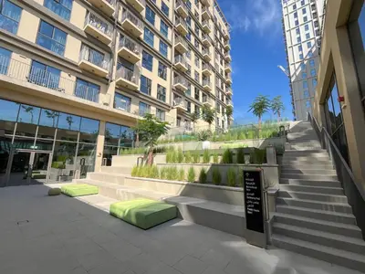a building with stairs in front of a building at Bright & Trendy 2BR in Collective, Dubai Hills in Dubai