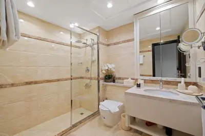 a bathroom with a shower and a sink and a toilet at 2-Bedroom Apartment with Full Burj Khalifa & Opera House Views Just 9 Min Walk to Dubai Mall! in Dubai