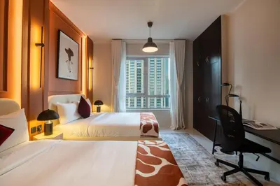 a bedroom with a bed and a desk and a window at 2-Bedroom Apartment with Full Burj Khalifa & Opera House Views Just 9 Min Walk to Dubai Mall! in Dubai