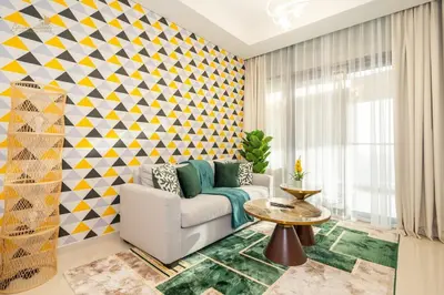 a living room with a couch and a geometric wall at Elegant Sunset View 3BHK 7pax in Dubai