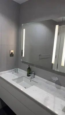 a bathroom with a sink and a large mirror at Royal bay Azizi Palm Jumeirah in Dubai