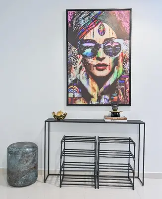 a black console table with a picture on the wall at New Luxury 2 Bedroom with Burj Khalifa View & Spectacular Rooftop Infinity Pool Bar in Dubai