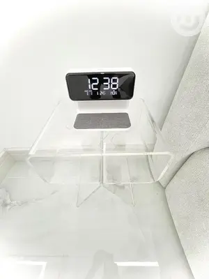 a clock sitting on top of a glass table at BRAND NEW luxury & modern in JLT in Dubai