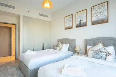 two beds in a room with white walls at 63rd High Floor - Full private Burj Khalifa and Fountain View - 2 Bedroom in Dubai