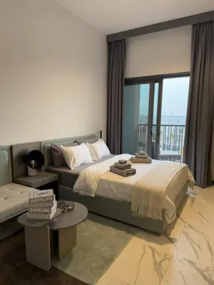 a bedroom with a large bed and a couch at Cozy Dubai Studio I Prime Spot in Dubai