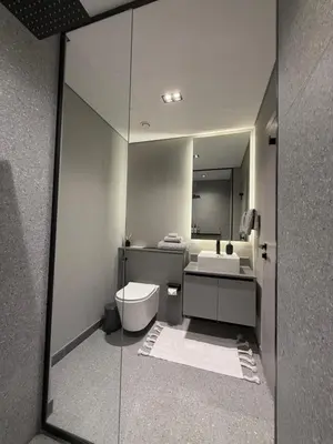 a bathroom with a mirror and a toilet and a sink at Cozy Dubai Studio I Prime Spot in Dubai