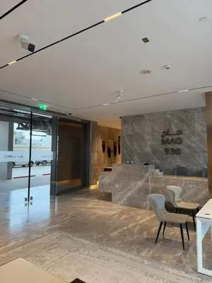 a lobby with a stone wall and chairs at Cozy Dubai Studio I Prime Spot in Dubai