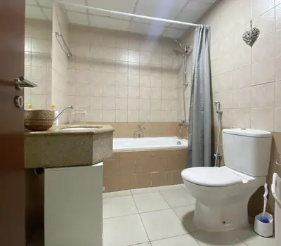 a bathroom with a toilet and a sink and a tub at Dubai Marina View, close to beach & metro in Dubai