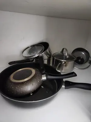 three pots and pans sitting on a kitchen counter at Dubai Marina View, close to beach & metro in Dubai