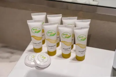 a group of four bottles of sunscreen on a table at Modern Meydan Studio Near Dubai Mall & Downtown in Dubai